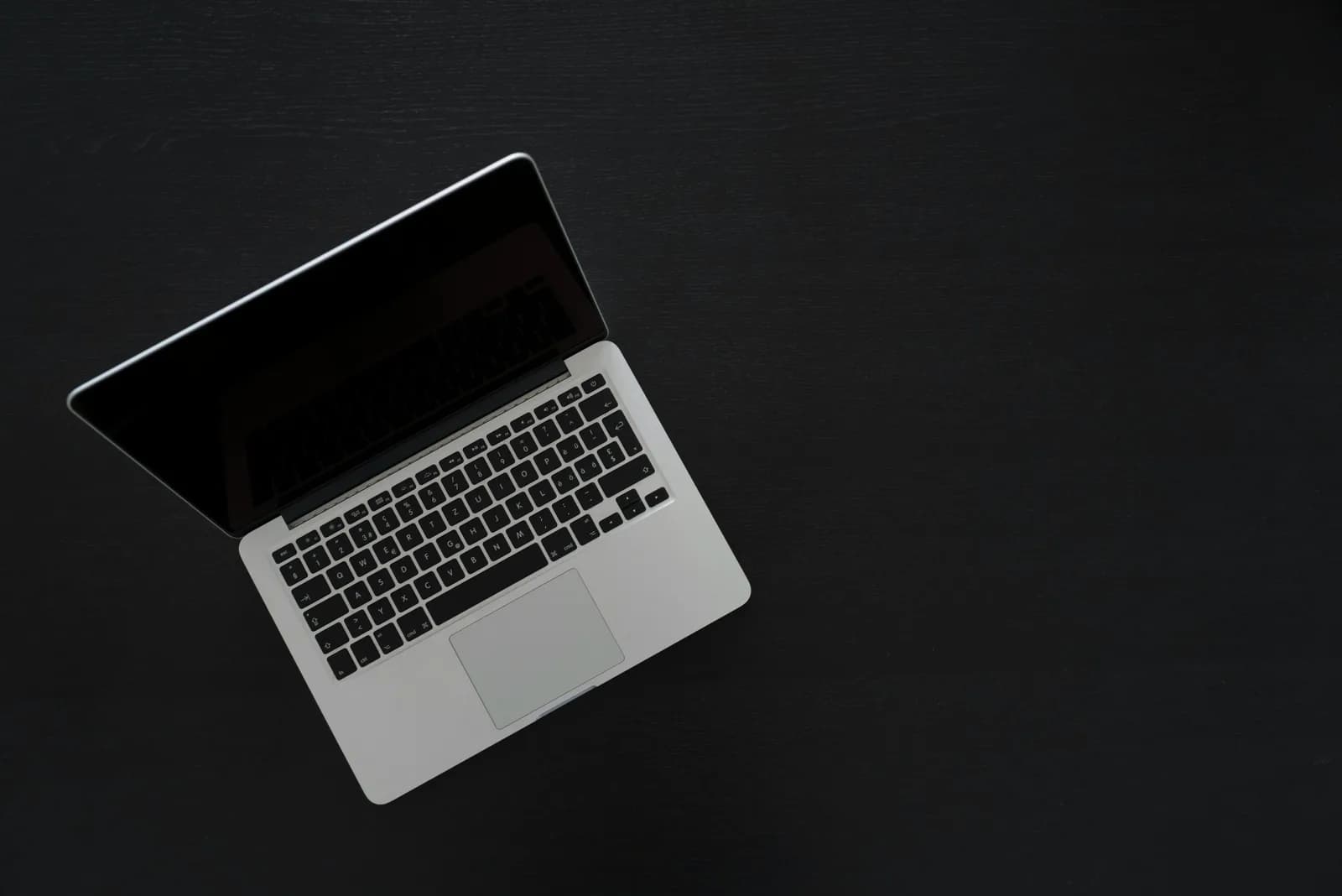 A MacBook on a clean, minimal desk, evoking everyday dictation and writing
