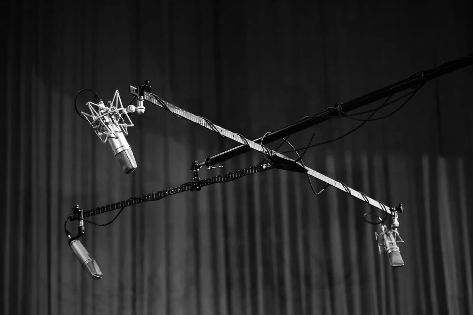 A studio condenser microphone on a desk in warm low light, evoking offline voice dictation