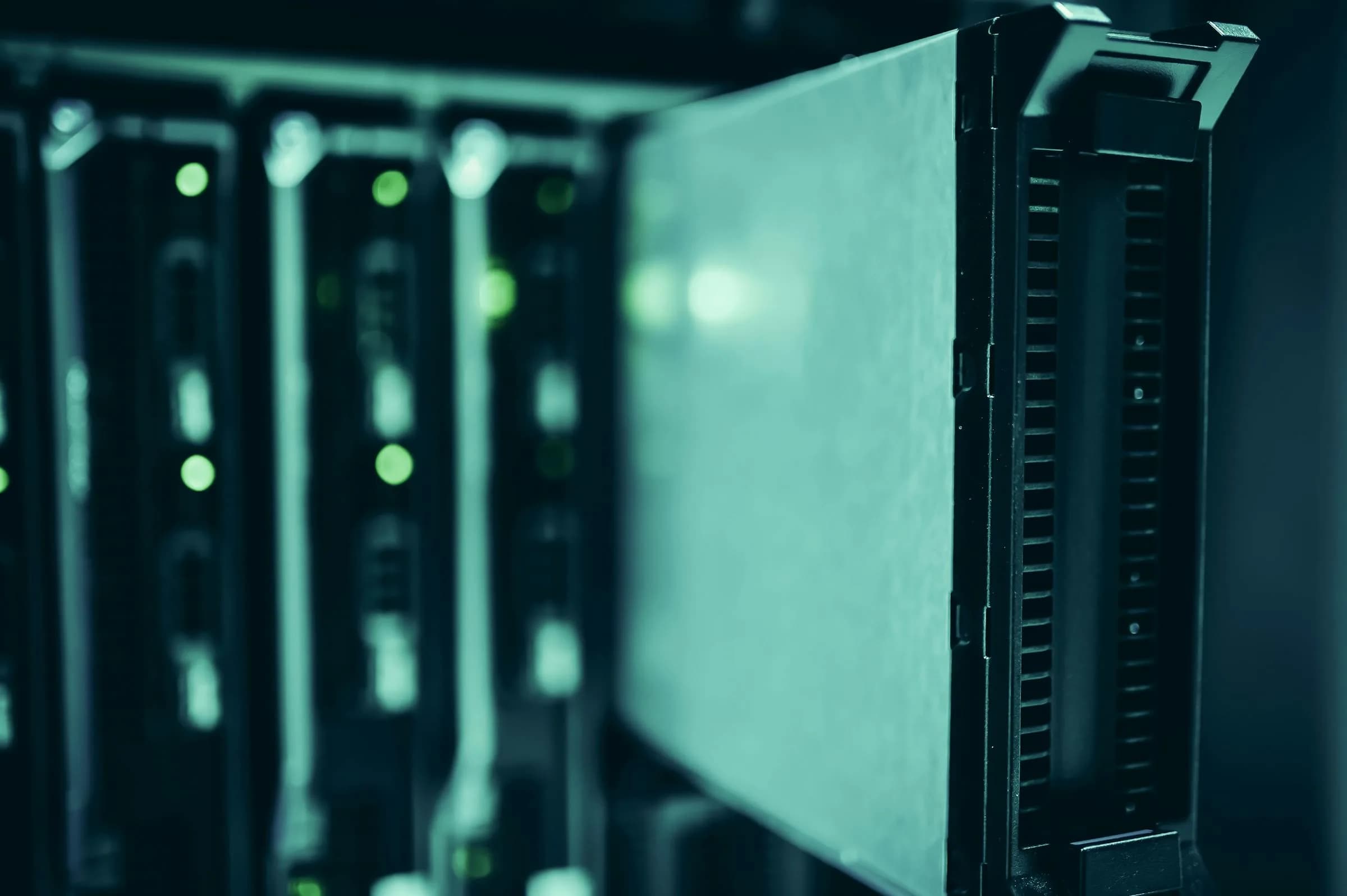 Rows of data center server racks with active equipment, representing cloud audio processing