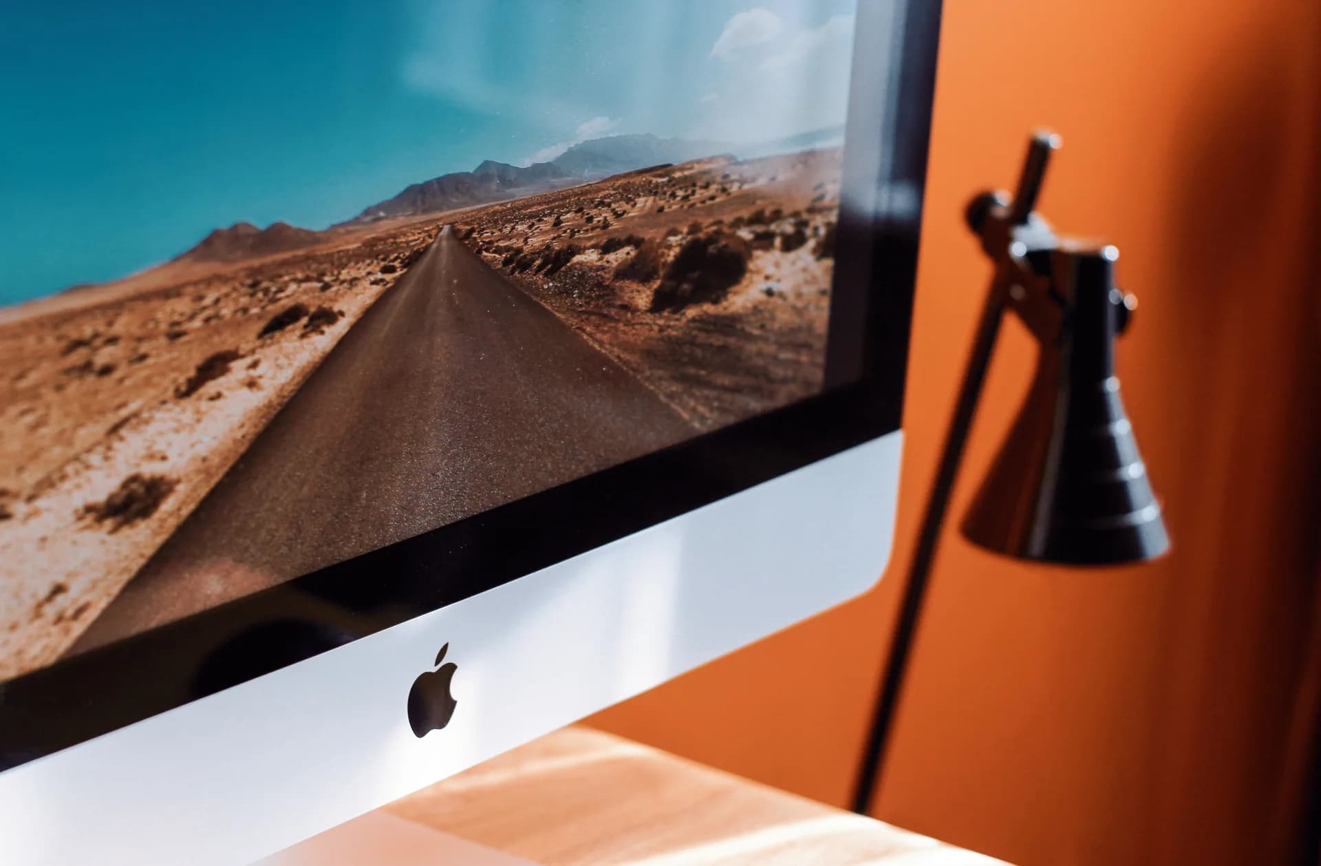 Sleek modern desktop workspace with a desktop computer on a clean desk, framing the choice of a Windows assistant tool