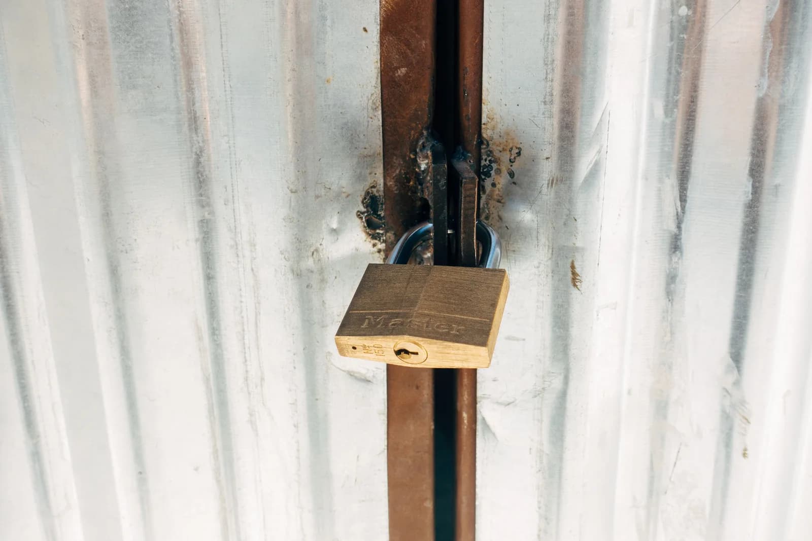A sturdy padlock securing a metal gate, illustrating local and offline privacy