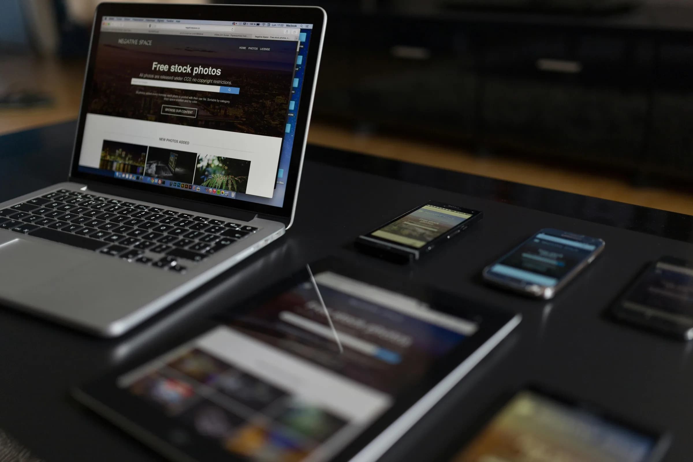 Contemporary workspace with a laptop, tablet, and smartphone arranged for working across devices