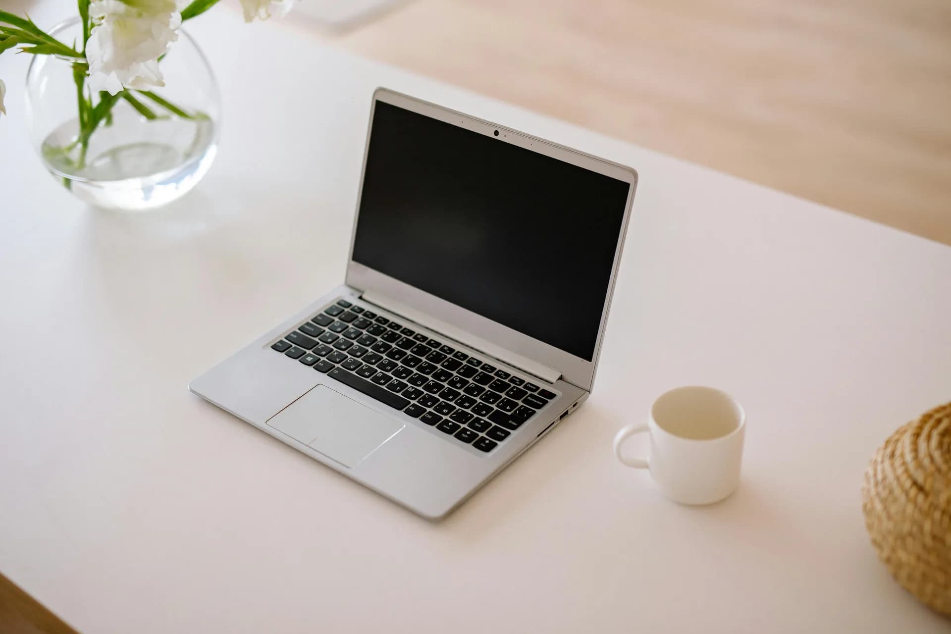 Open laptop on a clean white desk, framing the move from a browser dictation tool to a desktop one