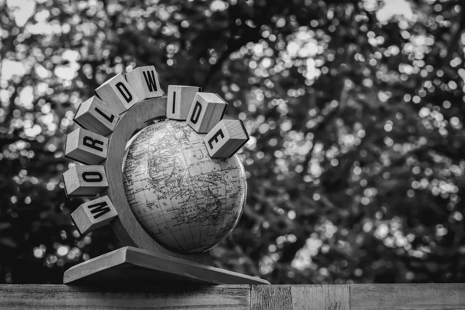 Black-and-white globe covered in worldwide text, hinting at a single locked-in language