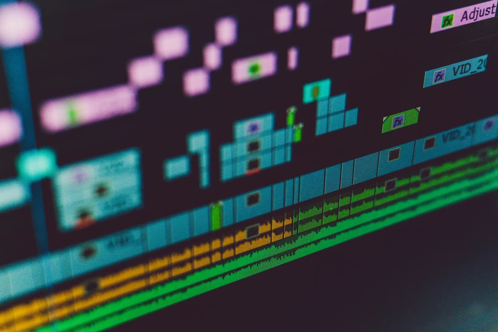 Multi-track editing timeline on a monitor, representing subtitle and file transcription workflows
