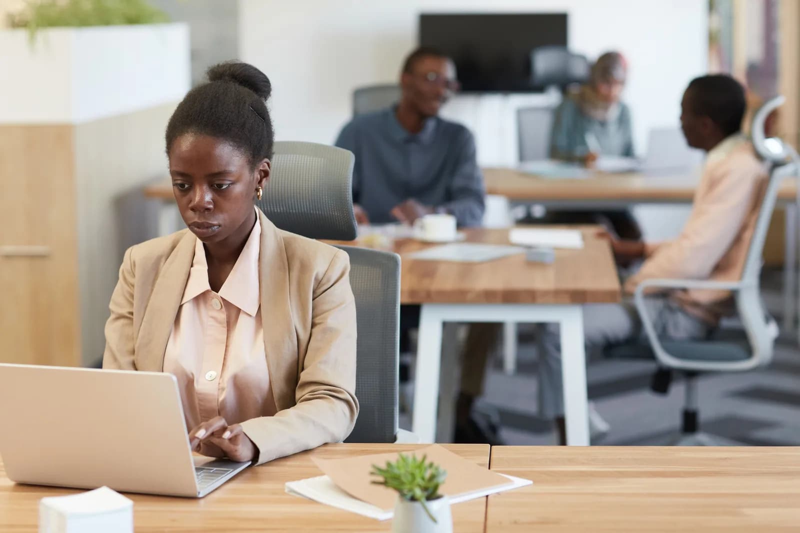 A person working on a laptop at a desk, representing on-device processing rather than cloud