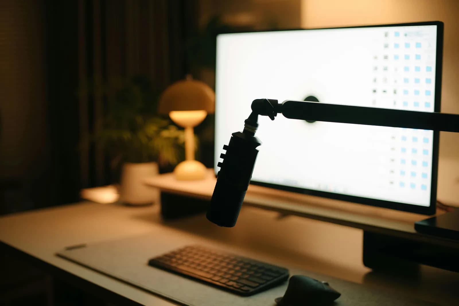 A desktop microphone beside a keyboard, illustrating speaking text instead of typing it