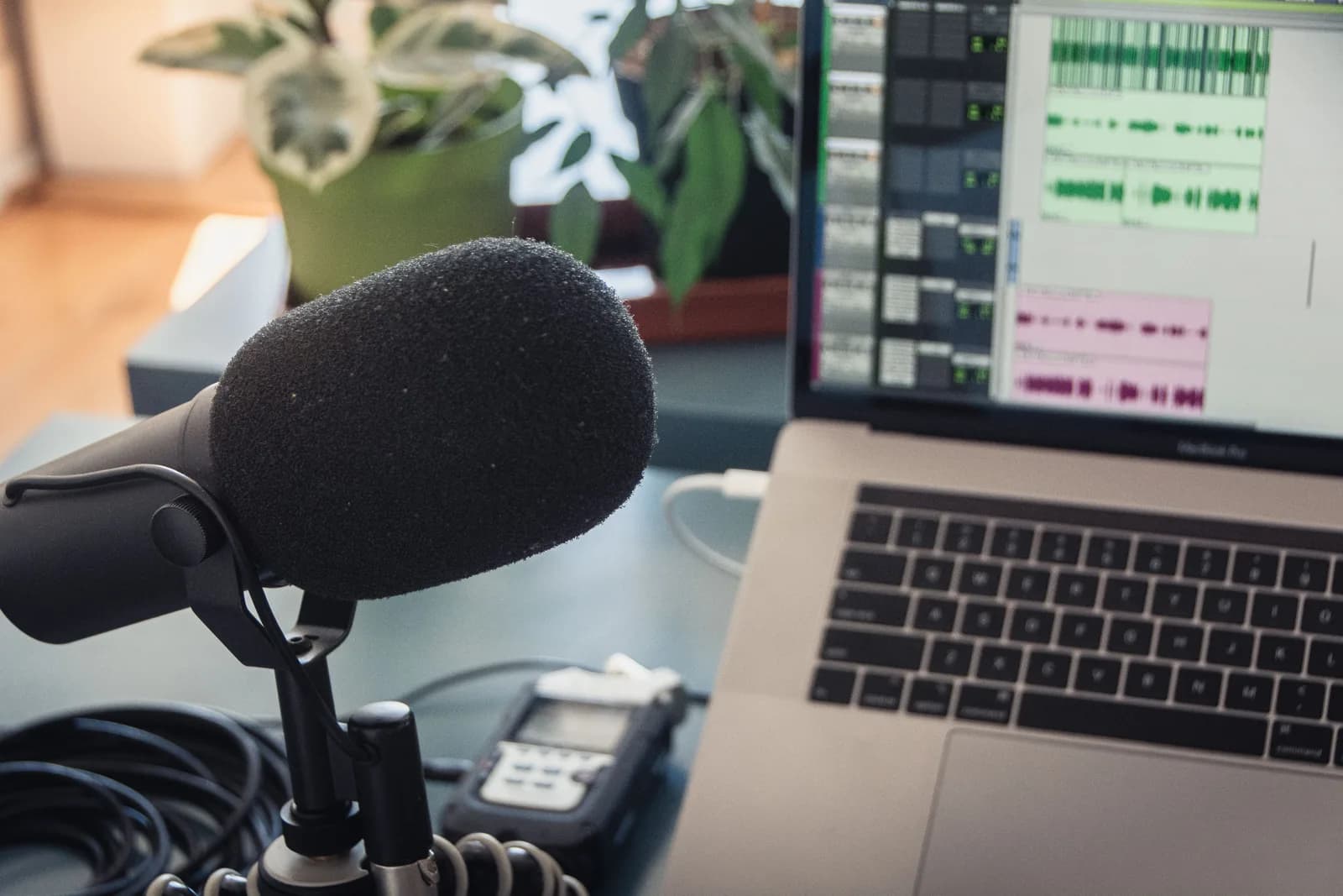 Audio waveform on a screen beside a microphone, representing speech turned into text