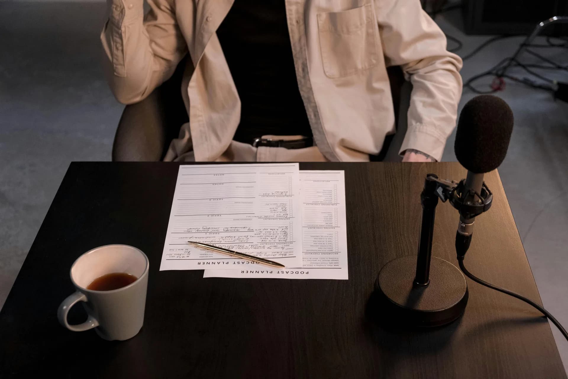 Desk microphone, papers and coffee cup in a quiet home workspace