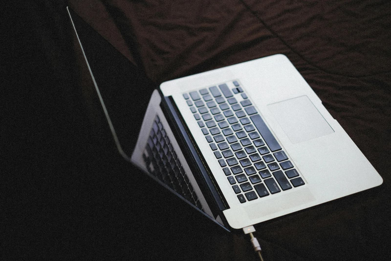 A closed padlock sitting on a laptop trackpad, illustrating on-device data privacy