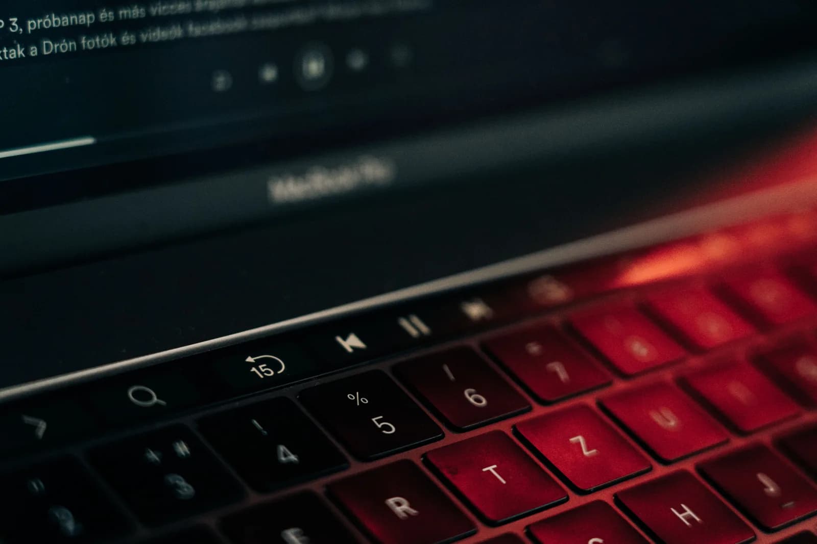 A padlock resting on a laptop keyboard in low light, suggesting a locked-down system setting