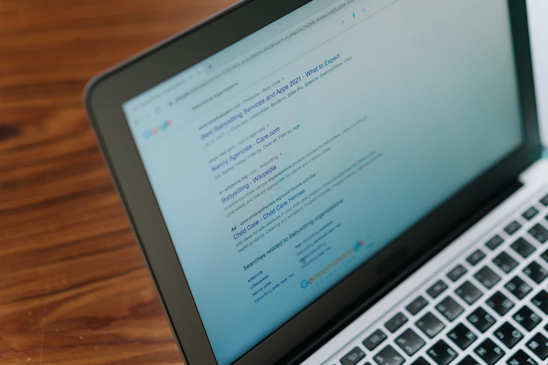 Laptop on a desk displaying a web search page, illustrating browser-based dictation tools