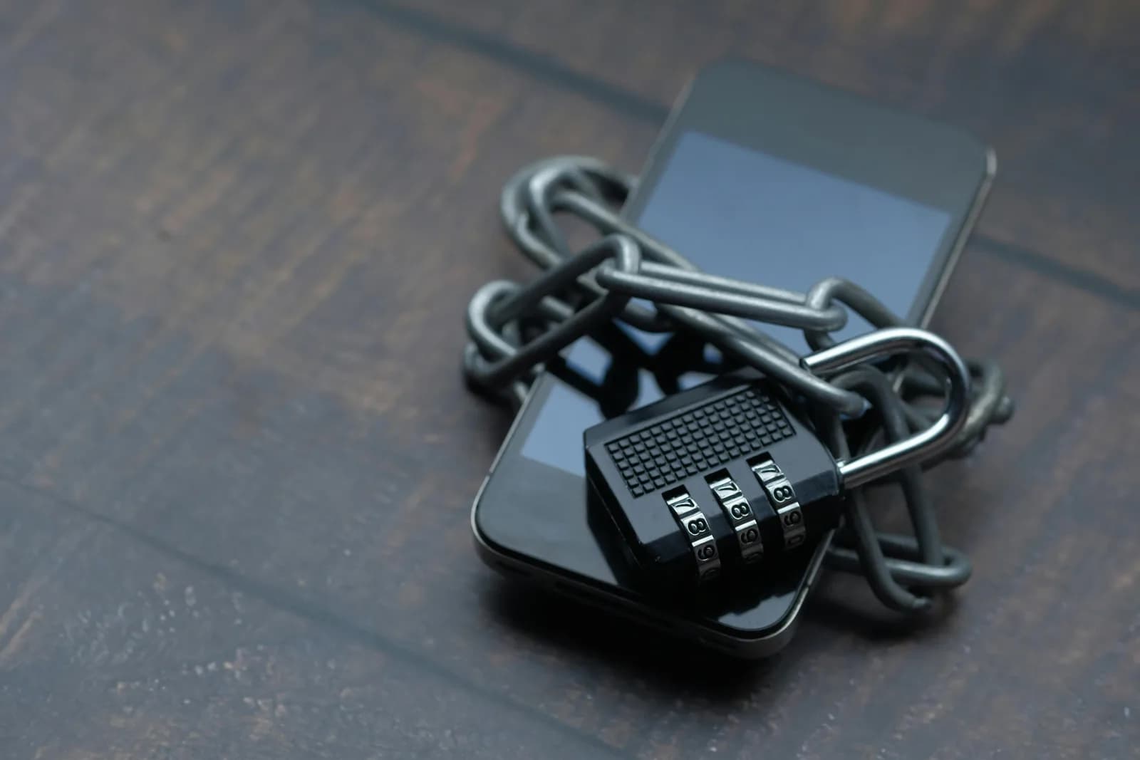 Smartphone wrapped in a chain with a padlock, symbolizing private, locked-down data