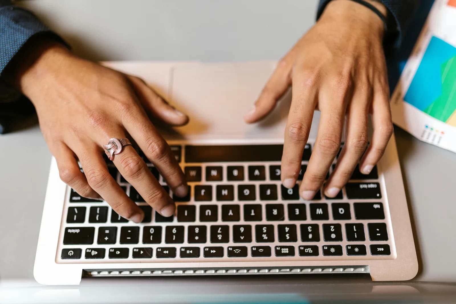 Hands typing on a laptop keyboard, representing free in-browser dictation