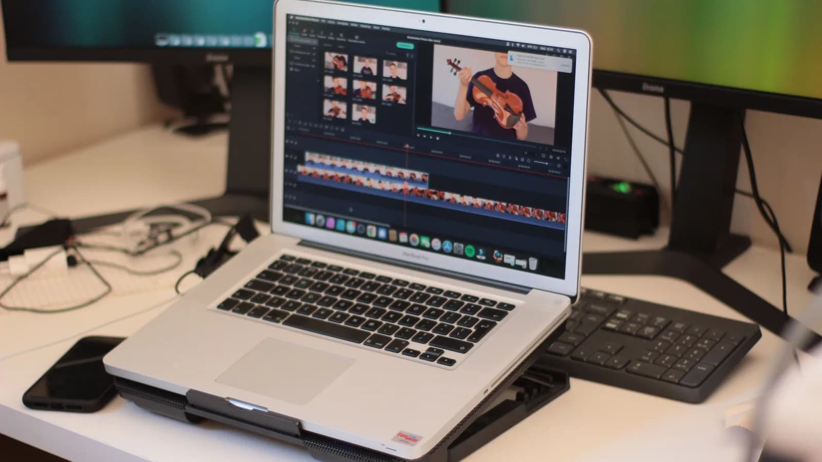 Laptop running video editing software on a modern desk, a setup for turning video into text