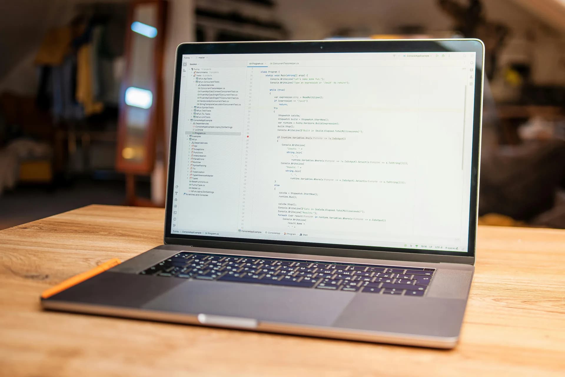Open laptop displaying source code on a wooden desk in a cozy modern workspace