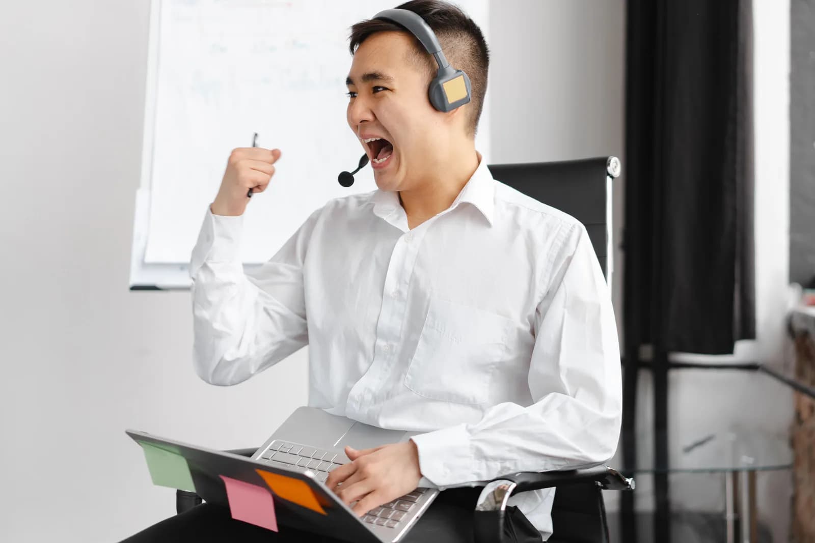 Person on a headset call beside a laptop showing a contact record, contrasting talking with typing