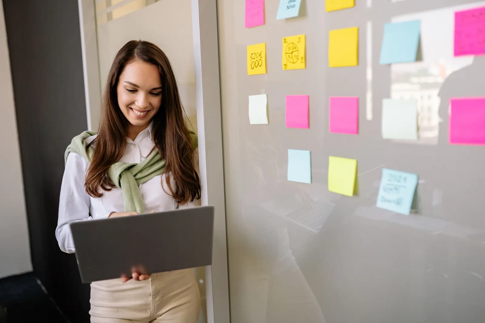 Colorful sticky notes on a glass wall during a planning session