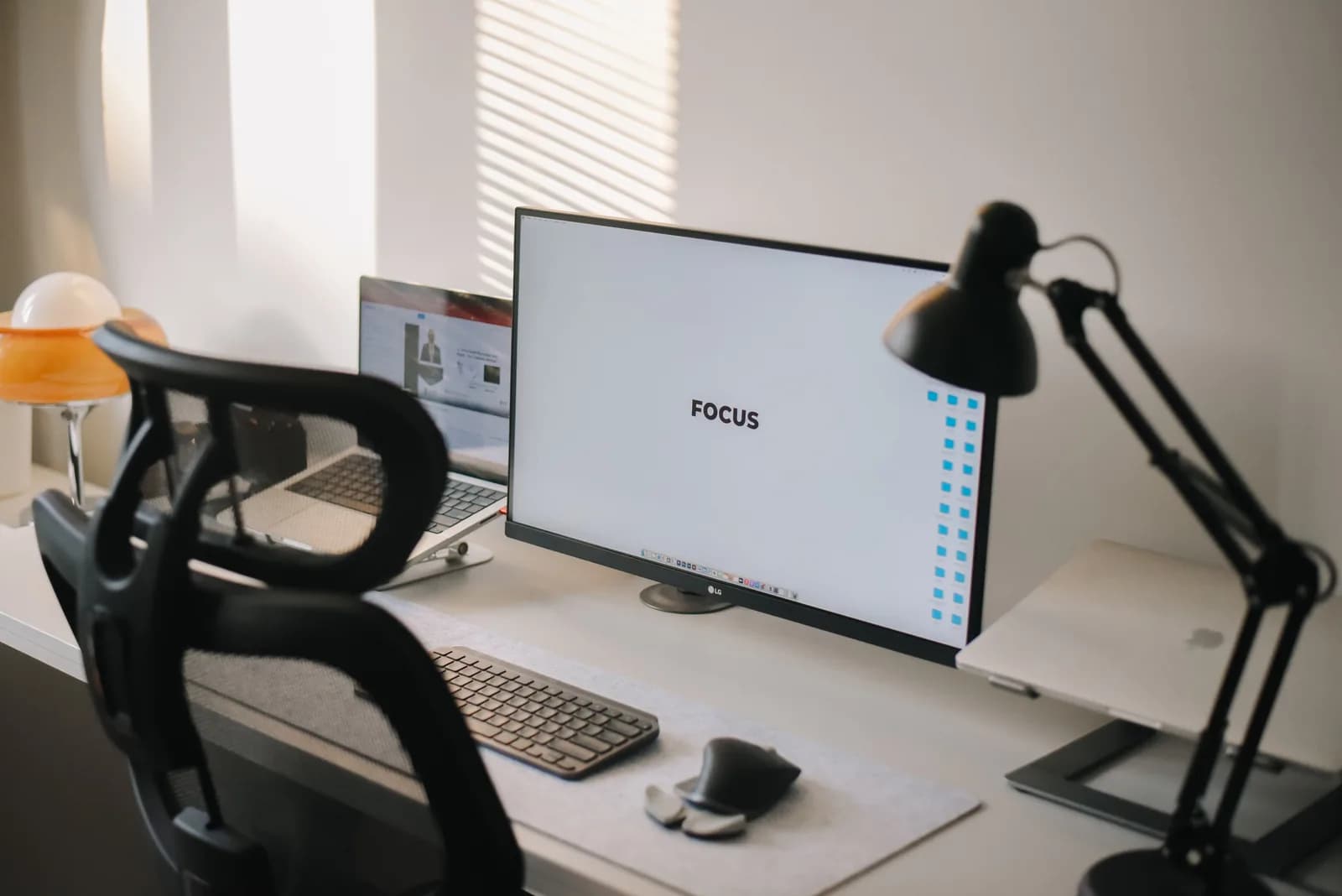 Clean modern desk with a large monitor focused on productivity, where work tools live side by side