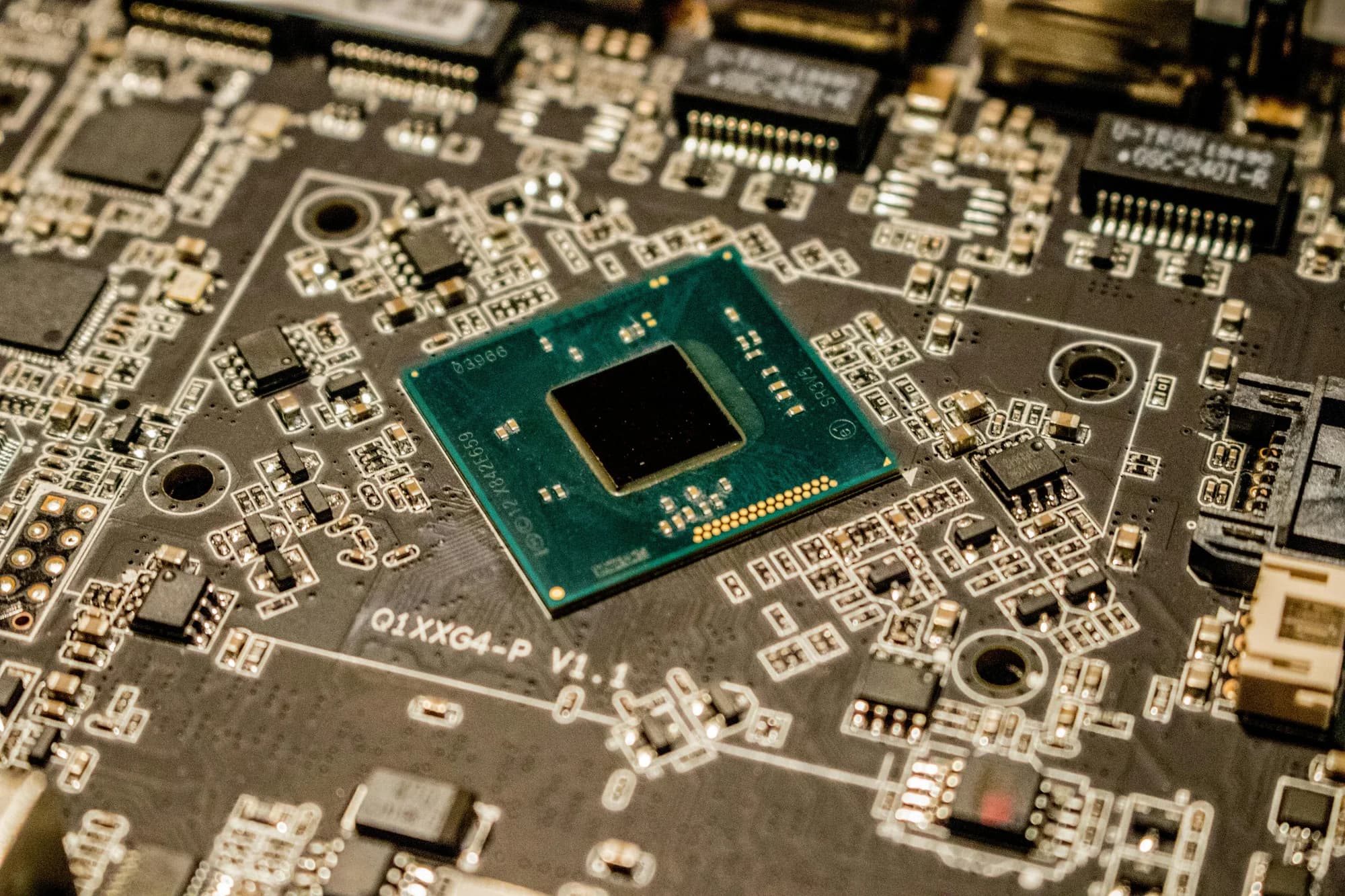 Macro shot of a microchip on a printed circuit board, representing the silicon that runs local Whisper models