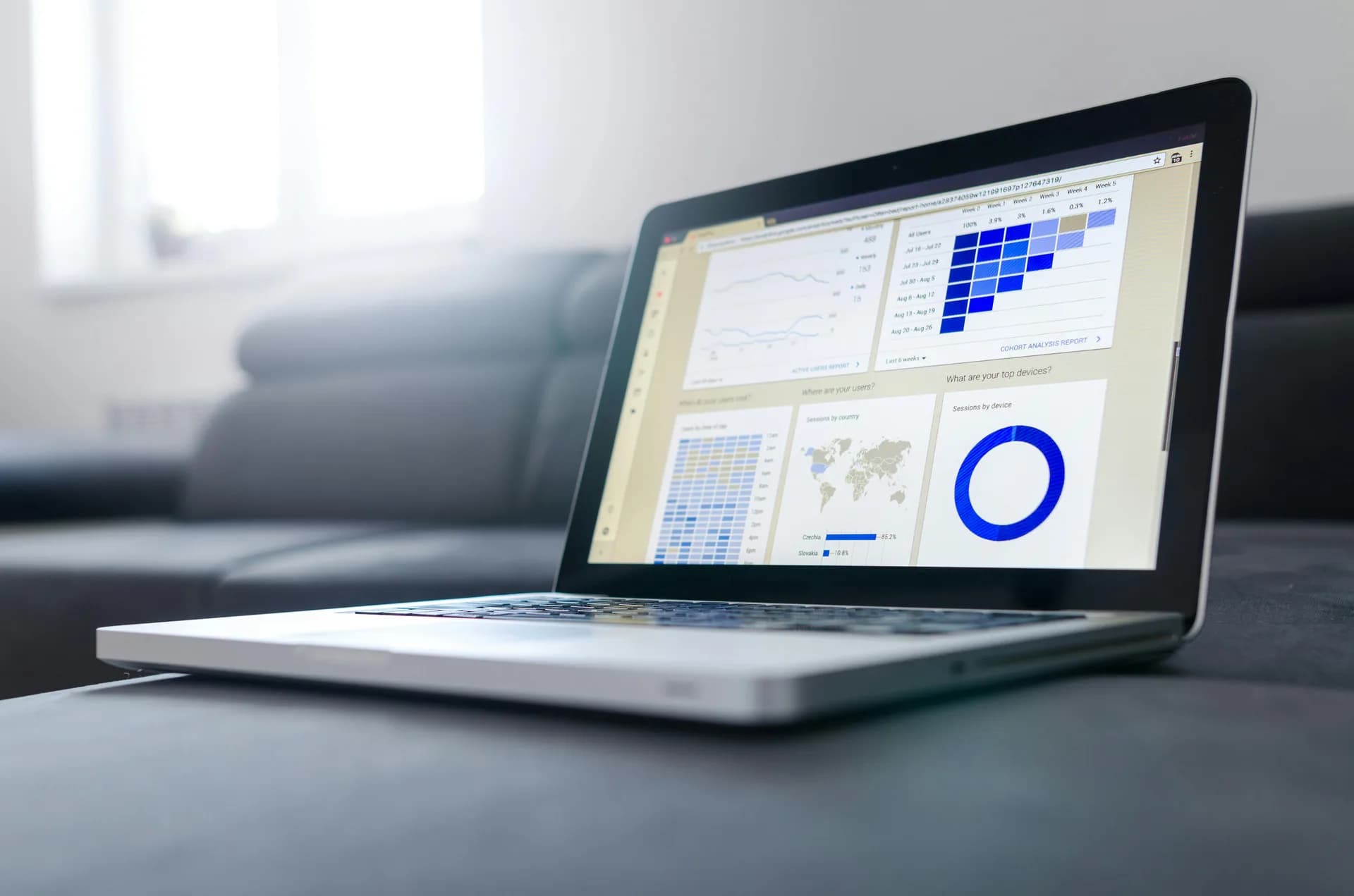 Laptop on a bright desk showing an analytics dashboard, evoking a CRM workspace for dictation