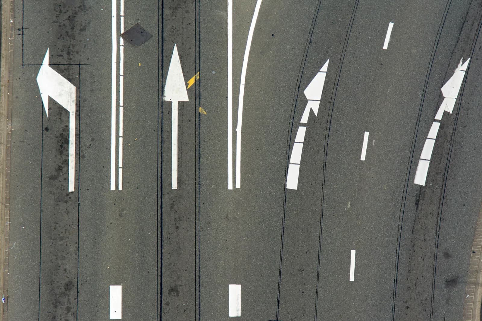 Two arrows painted on pavement pointing different directions, illustrating a tool choice