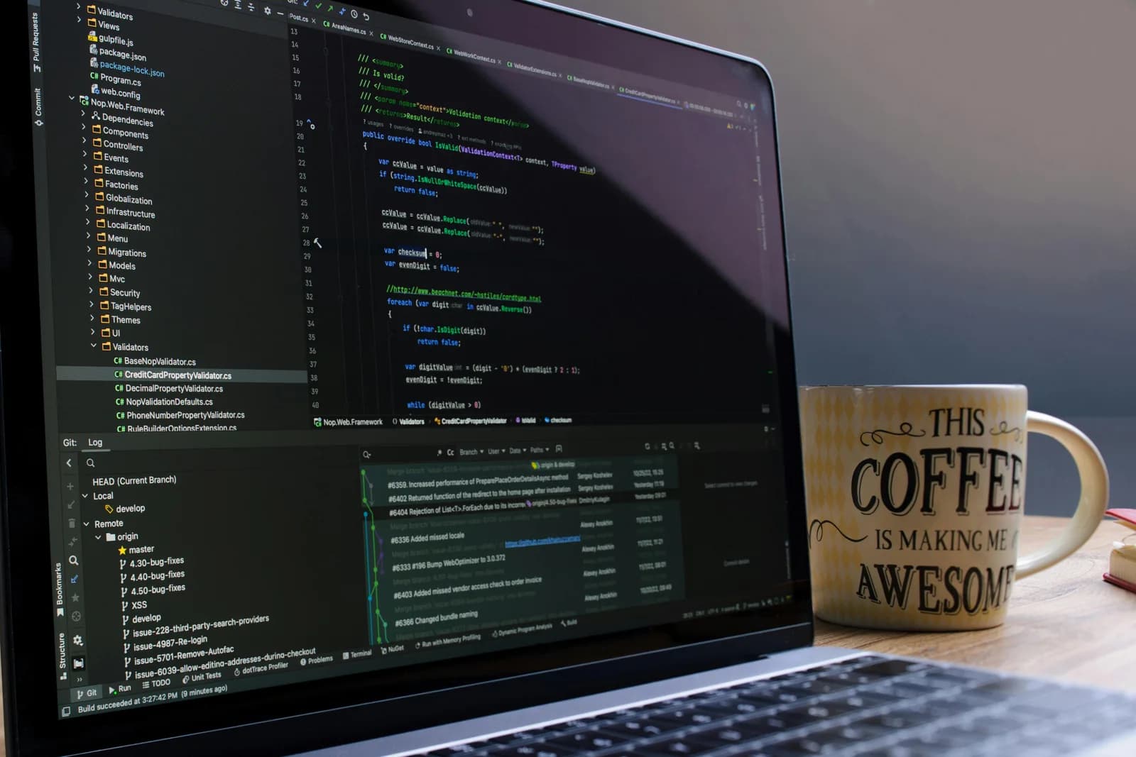 Close-up of a laptop running coding software beside a coffee mug, a typical editor setup before adding voice input