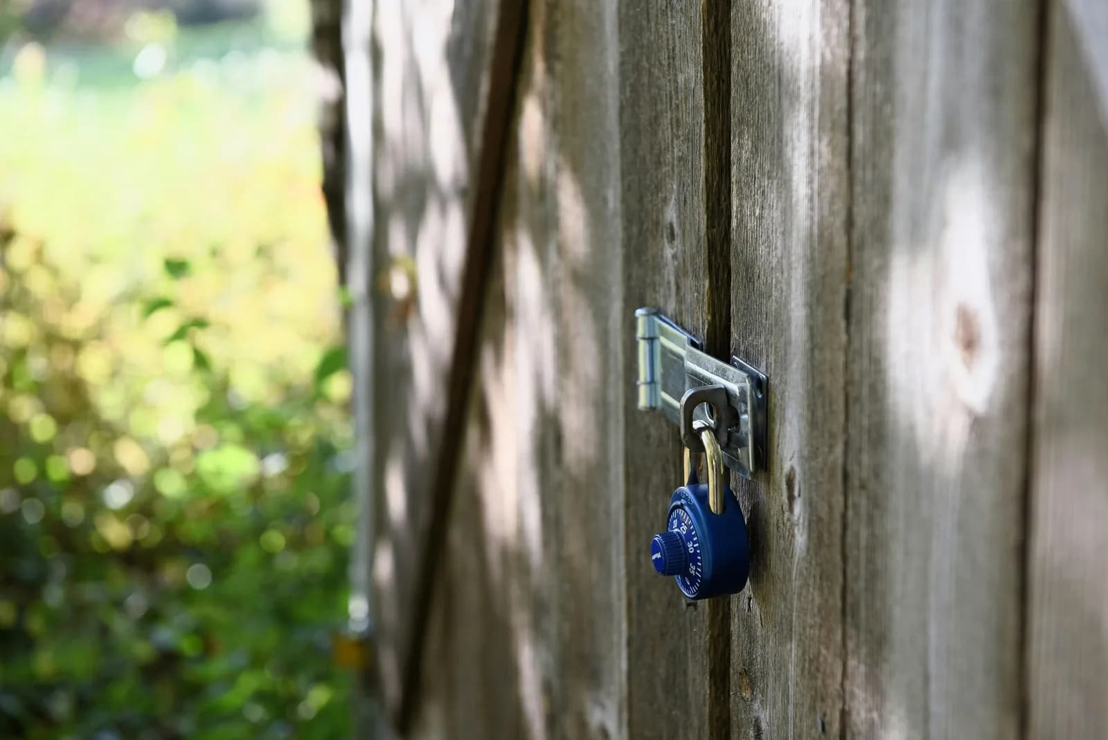 A blue padlock securing a gate in daylight, illustrating private on-device dictation