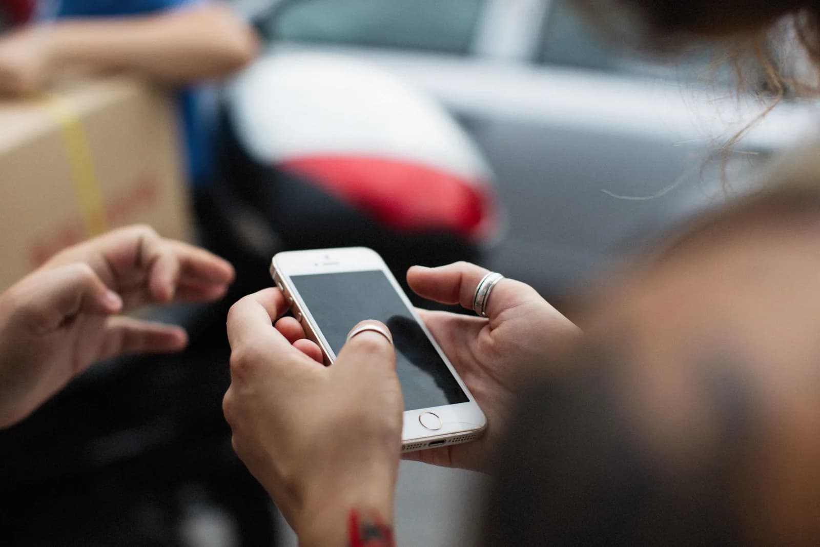 Hands holding a smartphone, where the built-in keyboard already does dictation