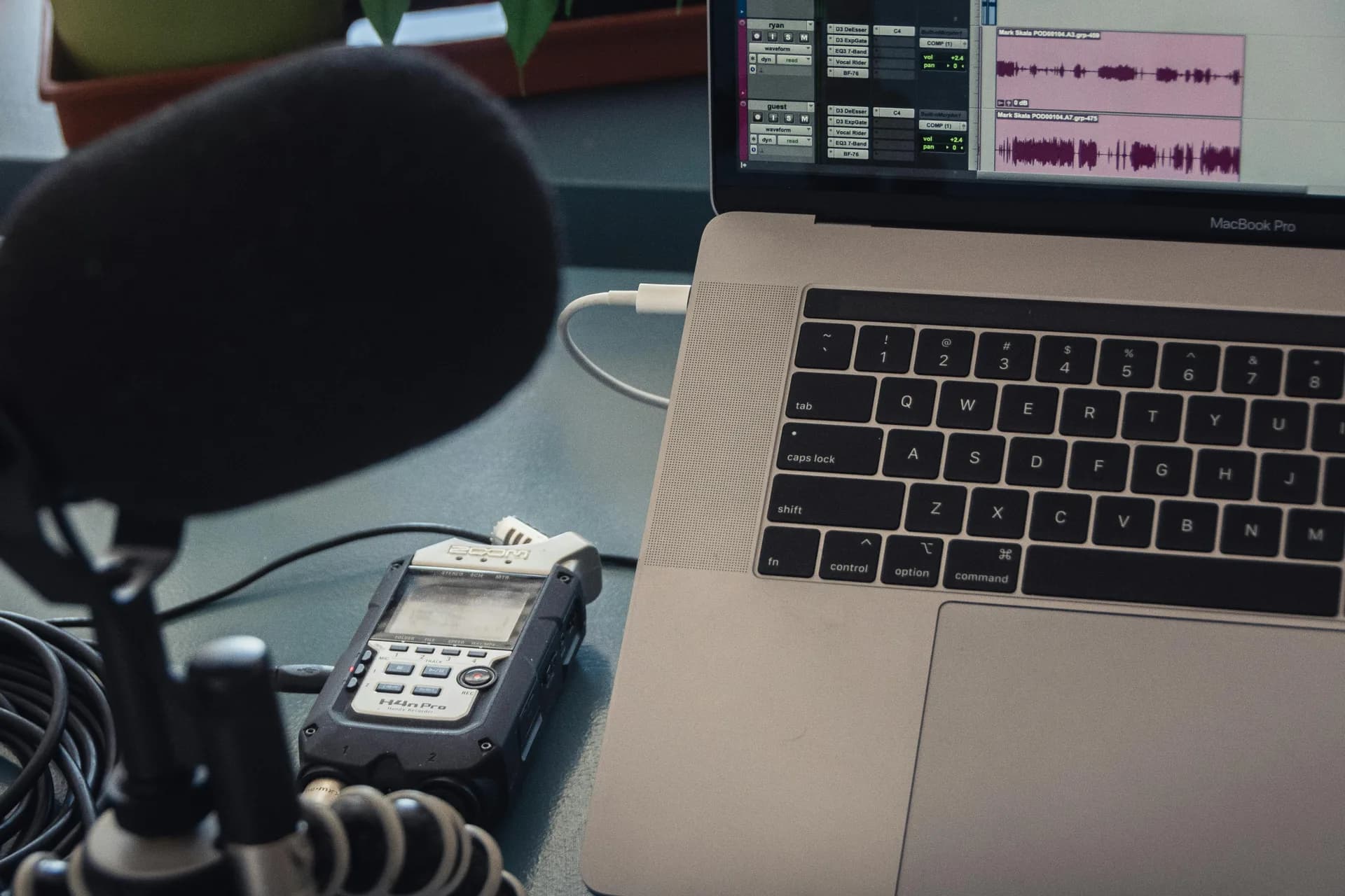 Microphone beside a laptop on a desk, the setup behind voice typing that has stopped responding