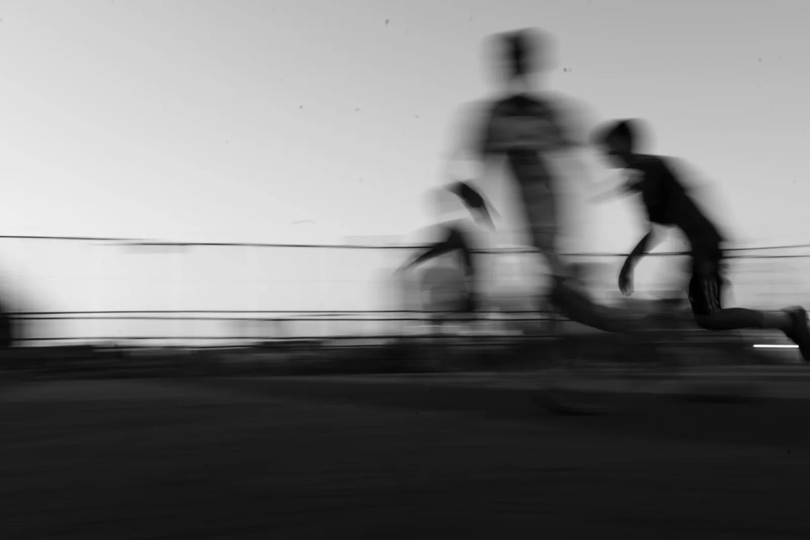 A runner in motion blur on a track, suggesting speed and a head start