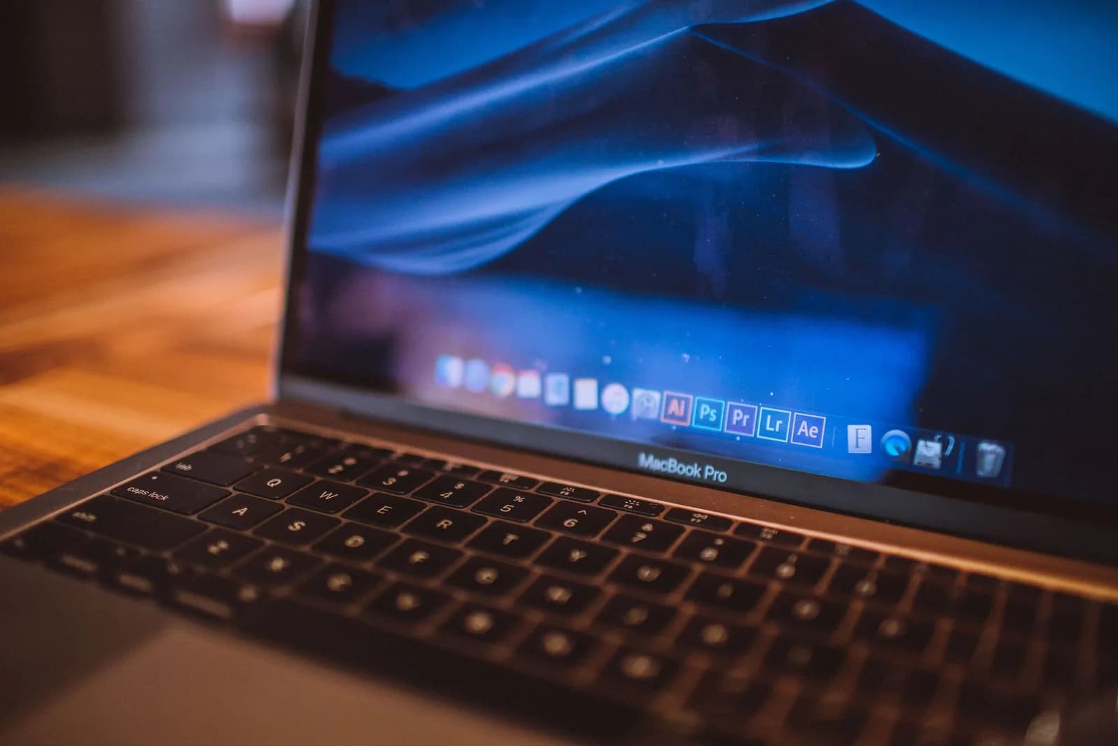 A MacBook and microphone on a desk, evoking Whisper voice dictation on Mac