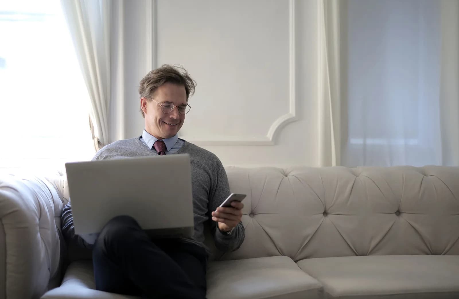 A person relaxed at a laptop sending a quick message, illustrating casual built-in dictation