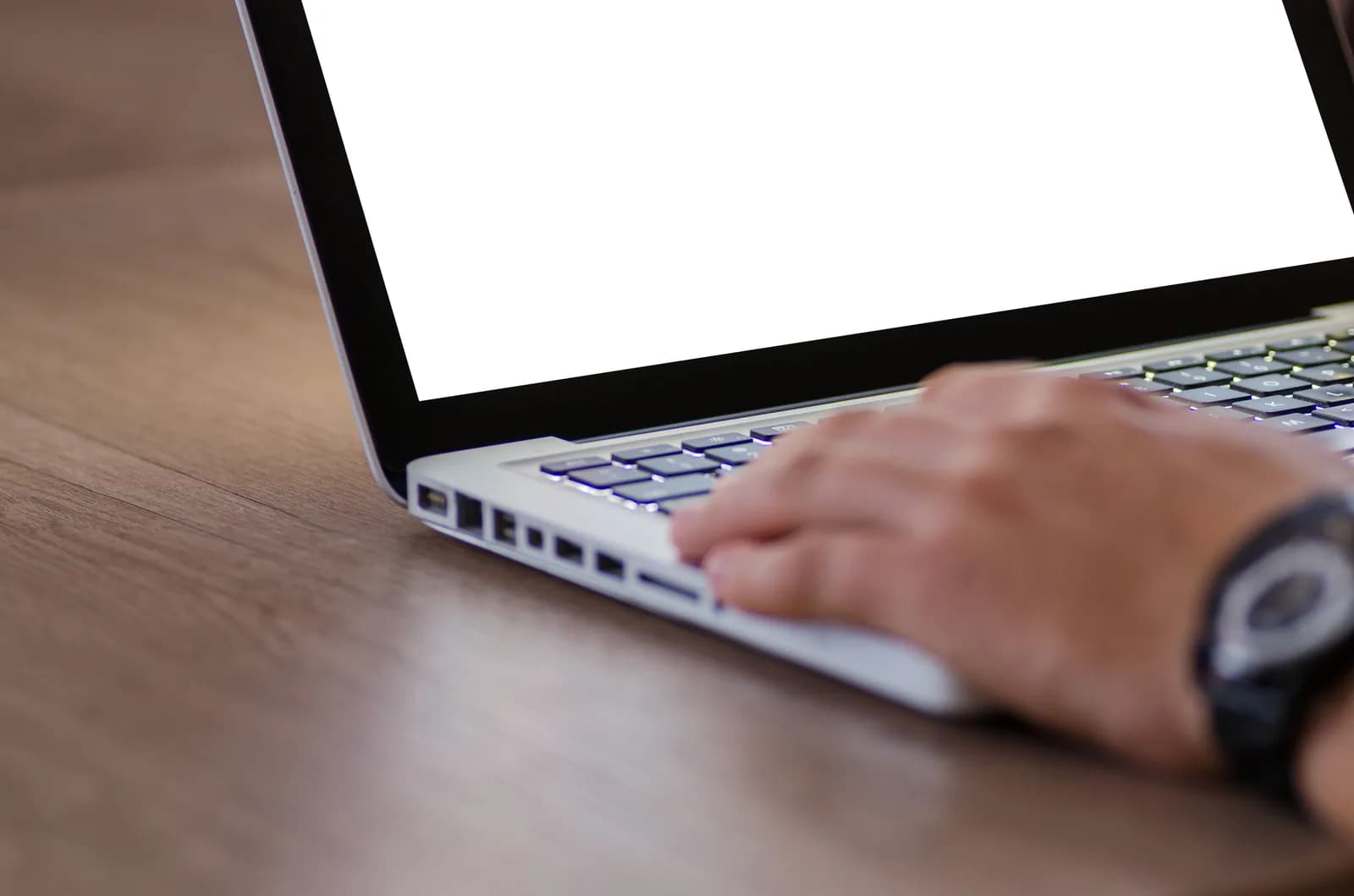 A hand on a laptop with a blank screen, a device that may be missing the speech feature