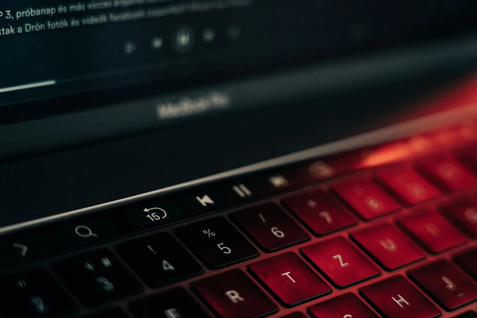 Close-up of a laptop keyboard on a dark desk with the Windows key in focus, evoking a stuck shortcut