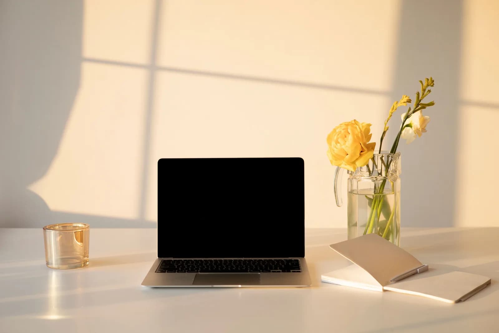 A calm, tidy desk with a laptop in soft light, suggesting a setup that simply works