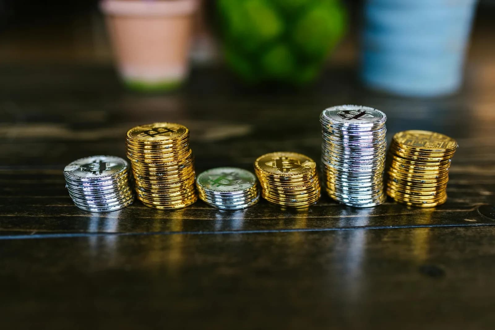 A small stack of coins on a clean white surface, used as a minimalist metaphor for everyday cost