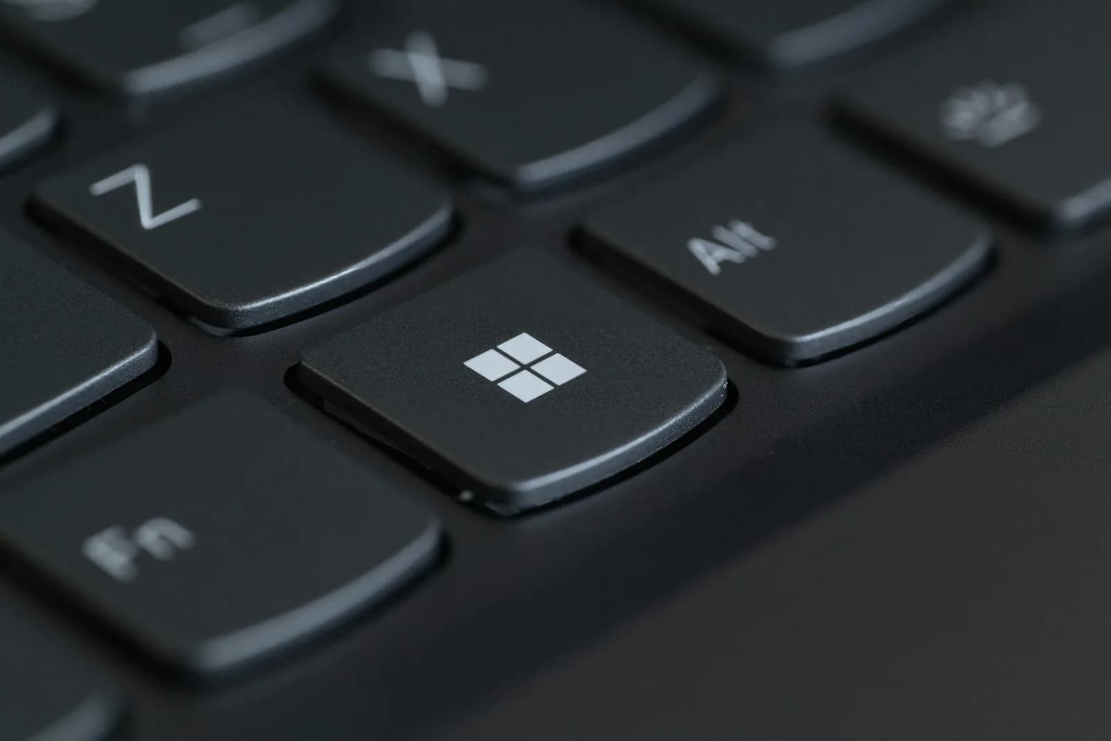 Close-up of a computer keyboard with the Windows key in sharp focus