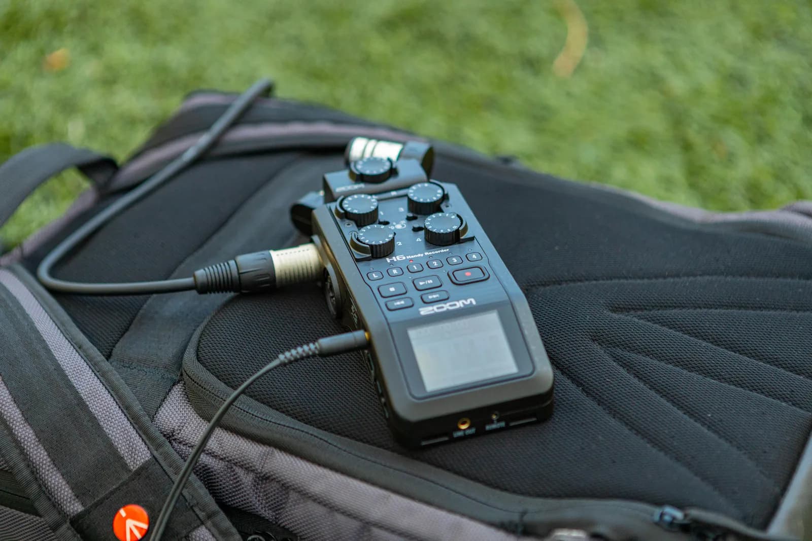Portable audio recorder clipped to a backpack, the on-the-go capture a recorder app handles well