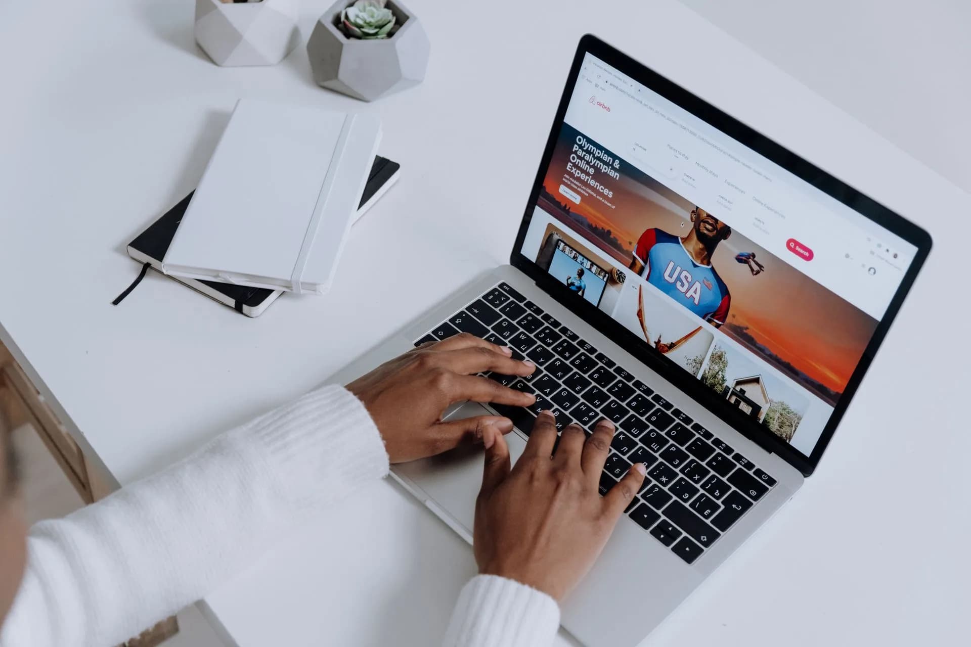 Hands typing on a laptop at a clean white desk, the browser workflow voice typing online replaces