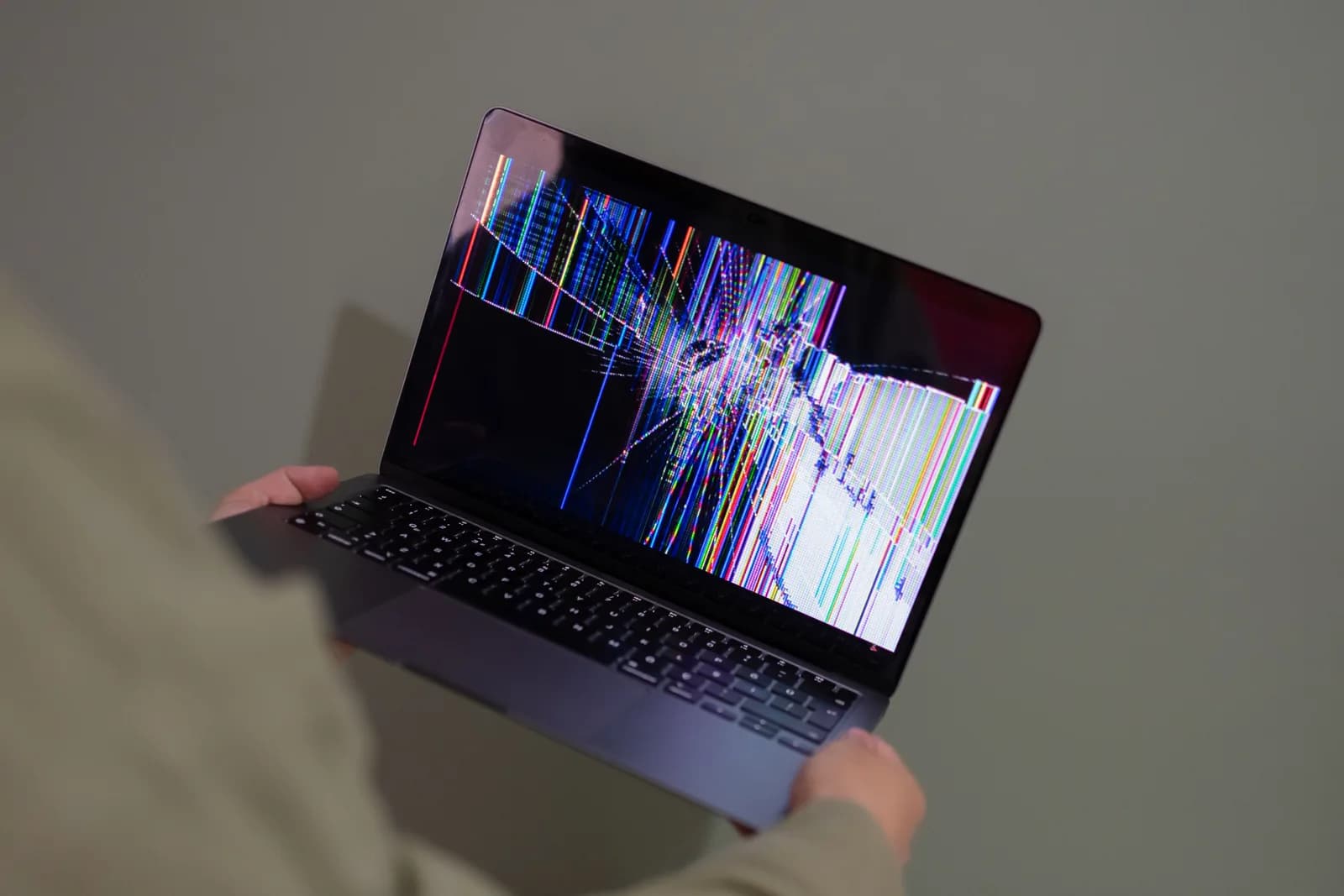 Laptop screen showing a colorful glitch pattern, illustrating an operating-system feature that suddenly stops working