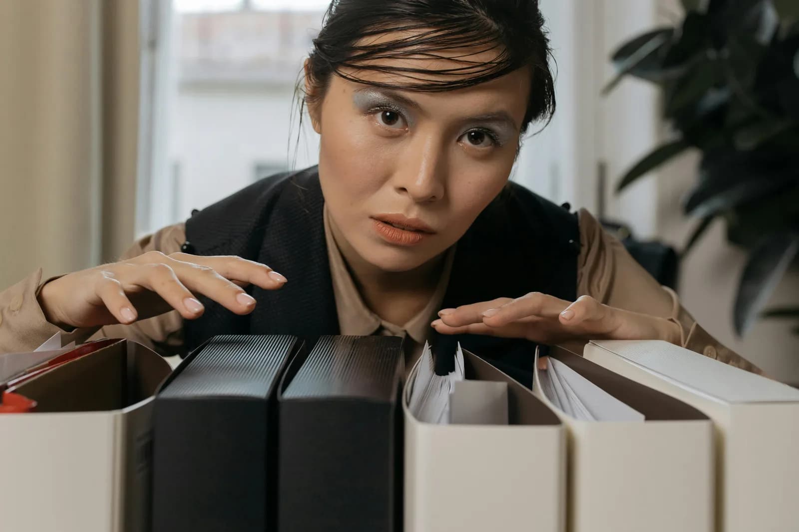 A person sorting files at a desk, illustrating the choice between dictation and file transcription