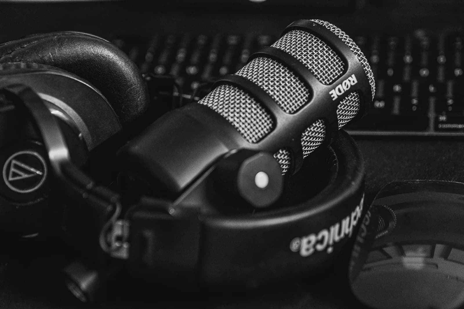 Studio microphone and headphones in a black and white close-up