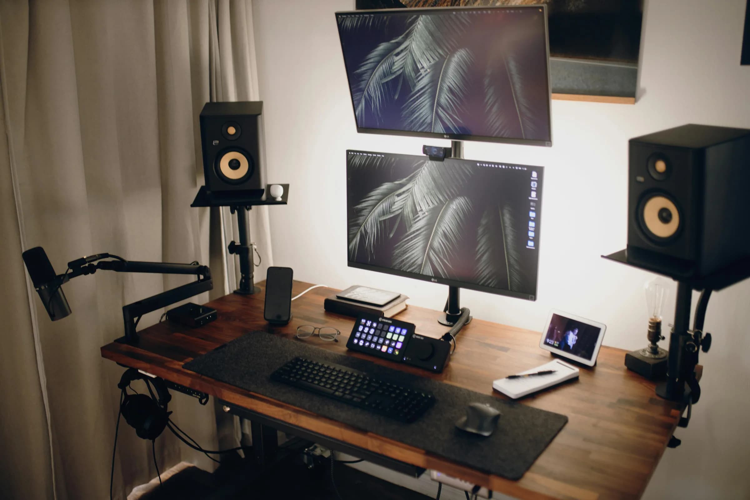 Streaming workstation with dual monitors, microphone, and warm bias lighting
