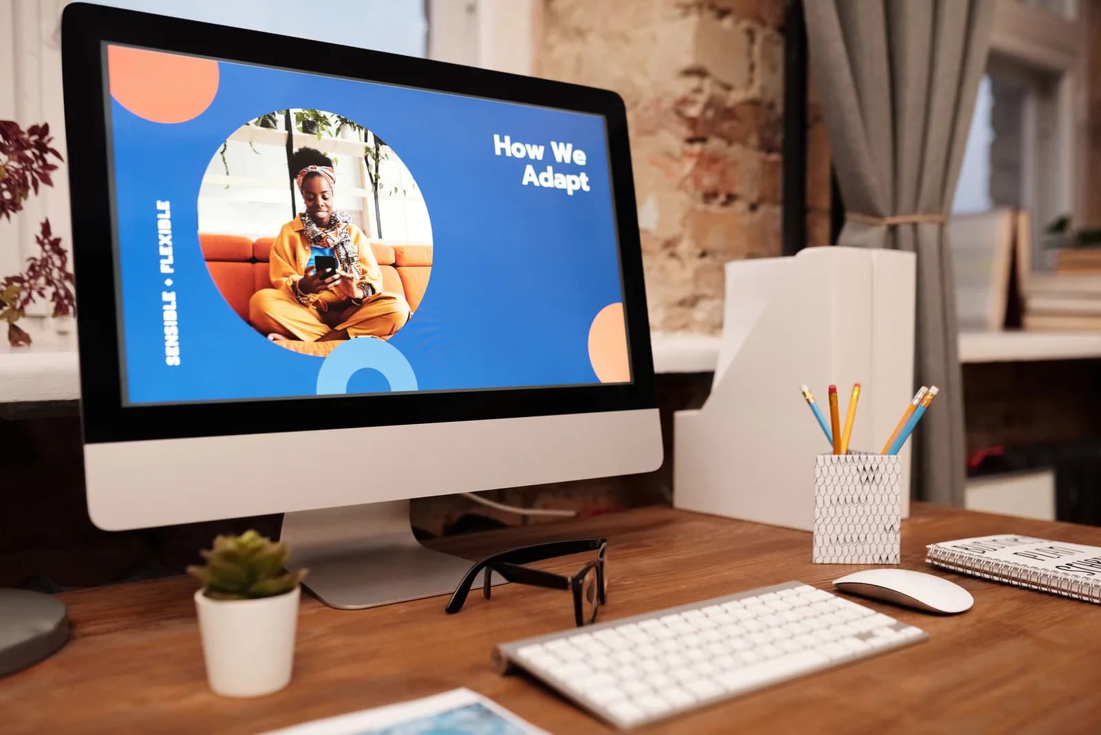 Desktop monitor on an office desk displaying a digital slide presentation