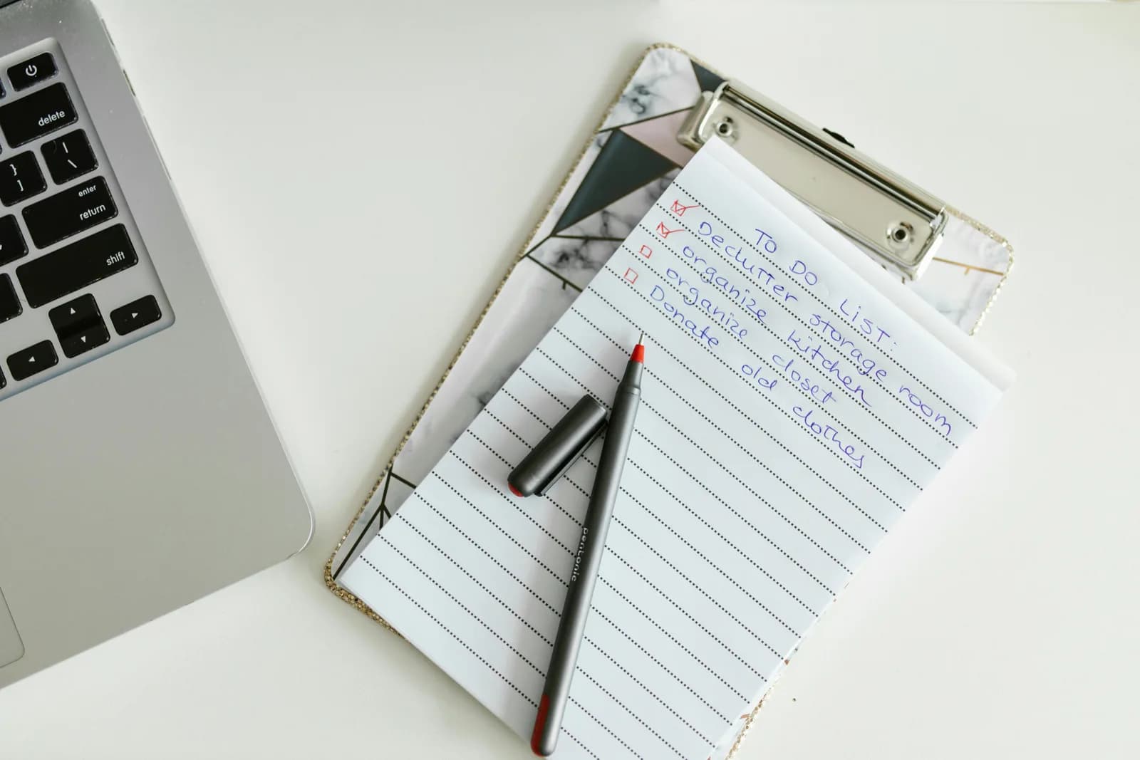 A tidy desk with a to-do list on a clipboard beside a laptop, the planning a Trello board replaces